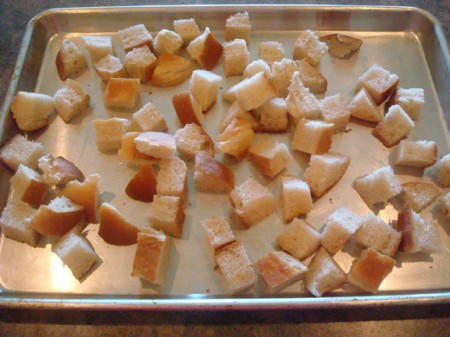 Bread cubes on baking sheet