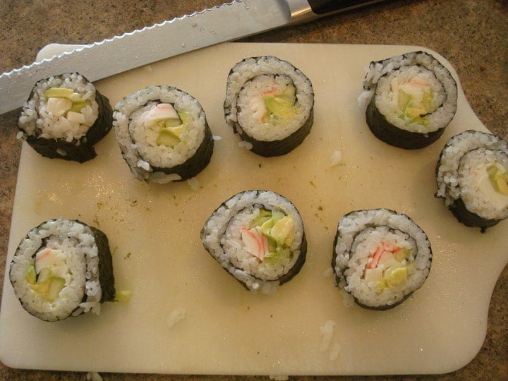 https://www.melskitchencafe.com/2010/04/california-sushi-rolls-a-how-to.html/seaweed-outside-rolls-cut-on-cutting-board
