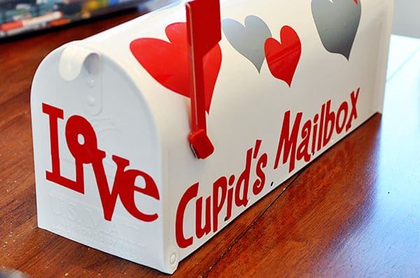 A white mailbox that says Cupid's Mailbox on the side.