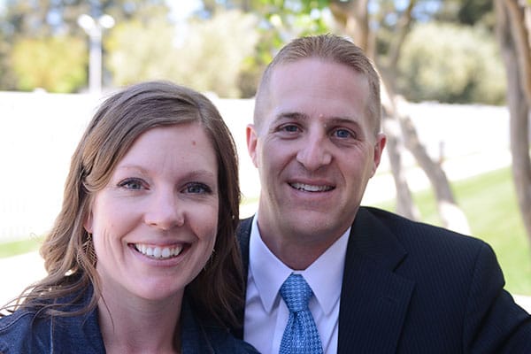 A man and woman pictured from the shoulders up.