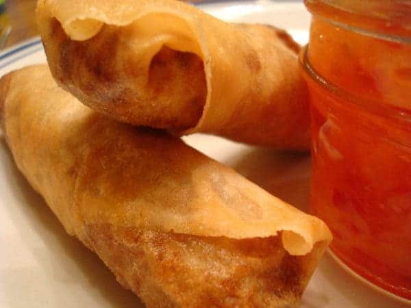 two egg rolls on a white plate