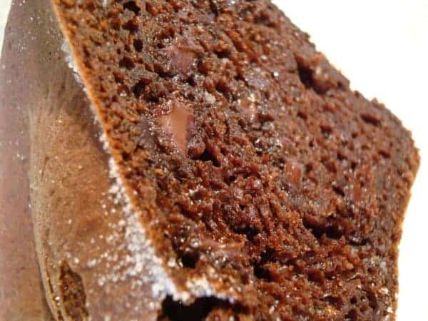 A slice of chocolate bundt cake with chocolate chunks.