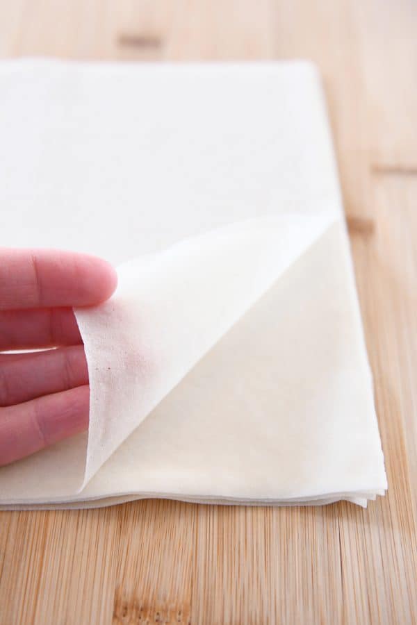 A stack of wonton wrappers on a countertop.