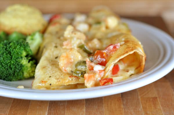 two shrimp Enchiladas on a white plate