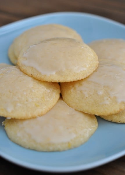 A blue plate full of glazed lemon buttermilk cookies.
