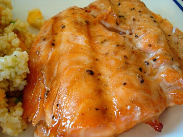 Grilled salmon fillet on a white plate.