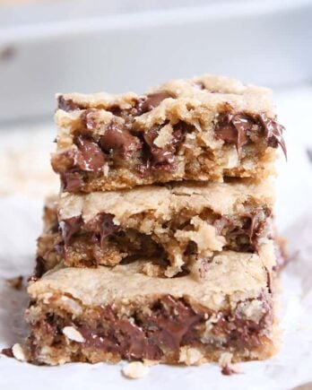 stack of three easy oatmeal chocolate chip coconut cookie bars on white napkin