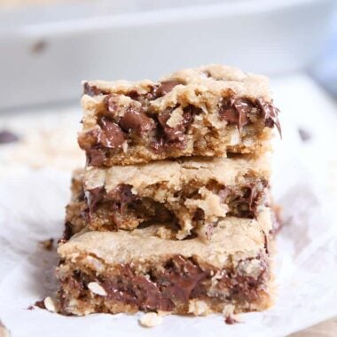 stack of three easy oatmeal chocolate chip coconut cookie bars on white napkin