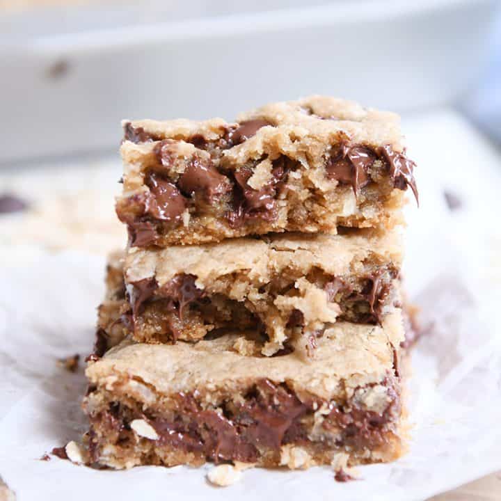 stack of three easy oatmeal chocolate chip coconut cookie bars on white napkin