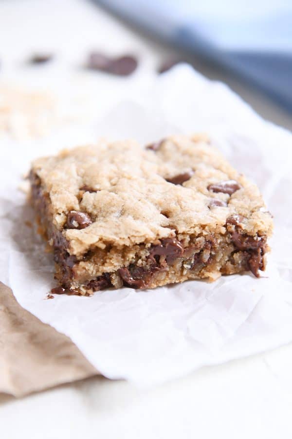 one oatmeal chocolate chip coconut cookie bar on white napkin