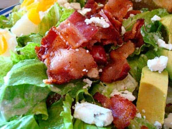 salad with bacon, avocado, egg, and feta cheese
