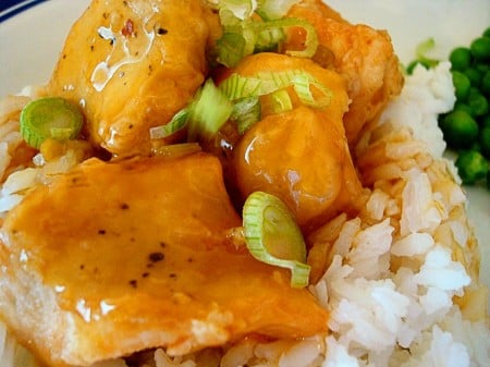 Orange chicken on a bed of rice.