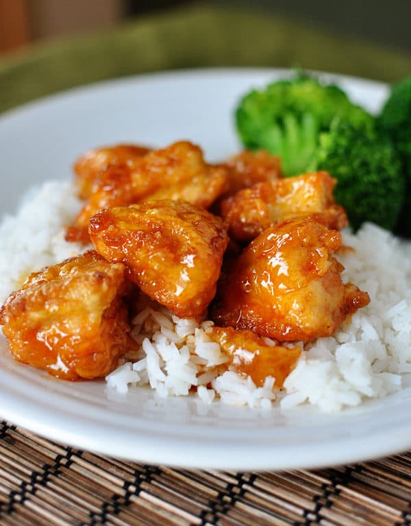 Homemade sweet and sour chicken on rice with a side of broccoli. 