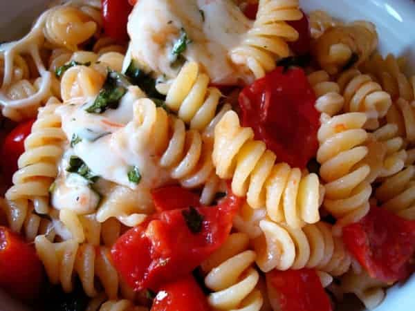 Spiral pasta with tomatoes and melted cheese.