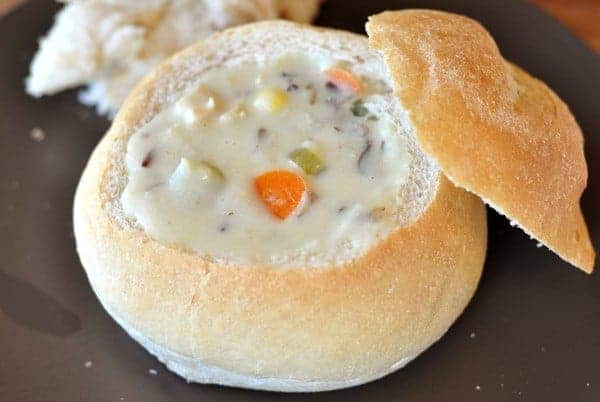 Bread bowl filled with creamy chicken soup.