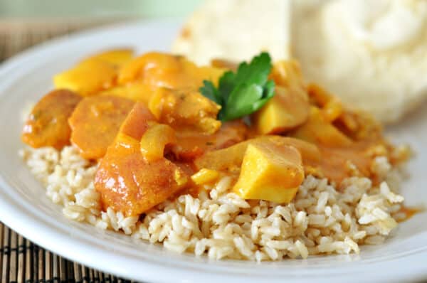 Brown rice top with cubed chicken and coconut curry sauce.