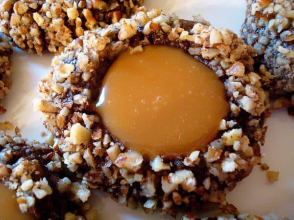 Top view of a chocolate turtle cookie filled with caramel.
