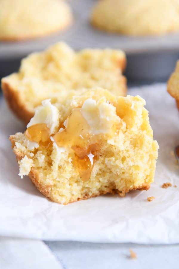 The best cornbread muffins split in half with butter and honey.