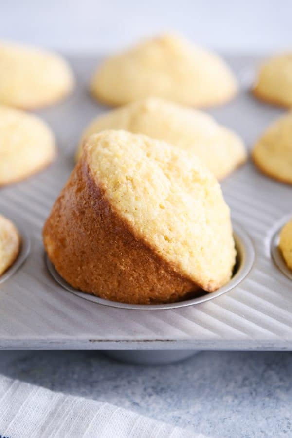 Baked cornbread muffin in pan.