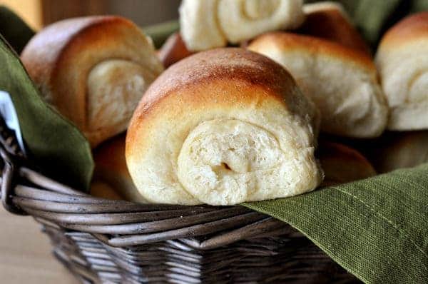 Basket full of golden brown rolls.