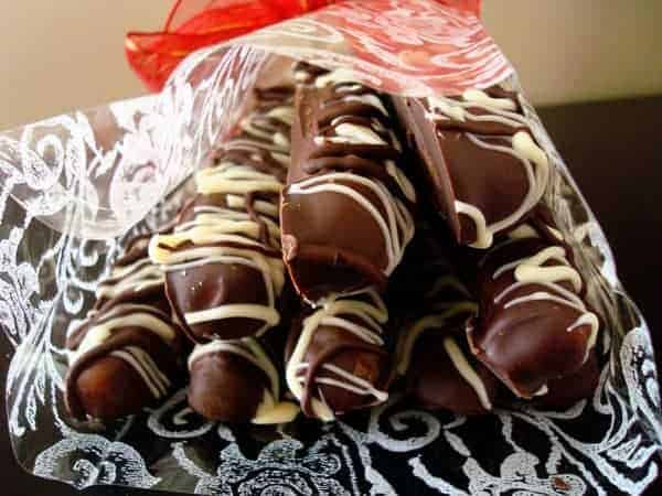 Stack of white and chocolate dipped pretzel rods.