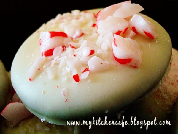 White chocolate dipped cookie with crushed candy canes on top.