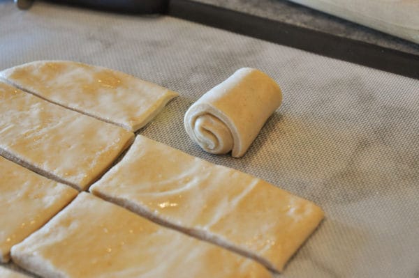 small rectangles of bread dough with one rolled up into a snail shape