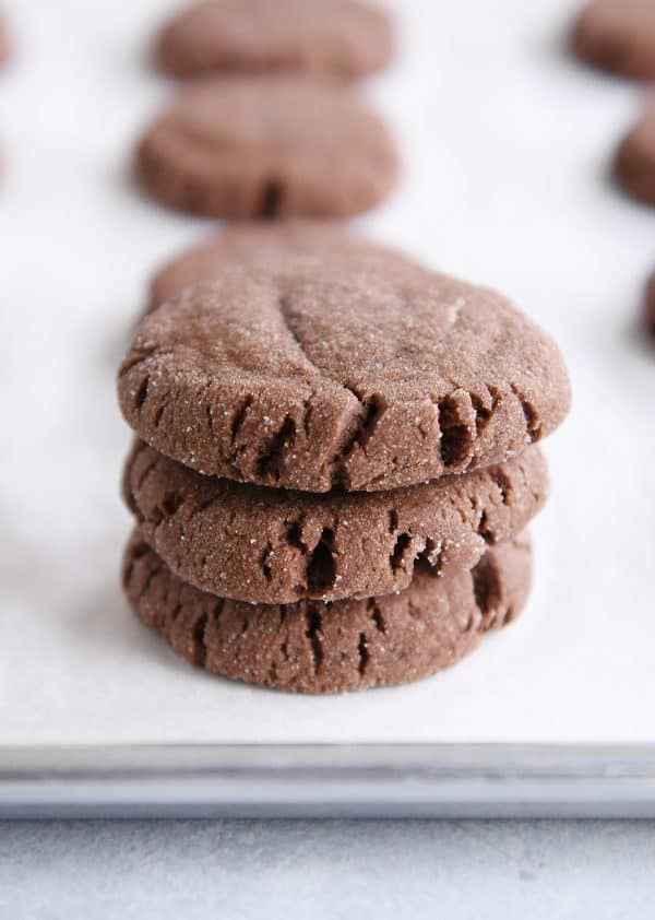 Stack of three baked chocolate peanut butter stuffed cookies.