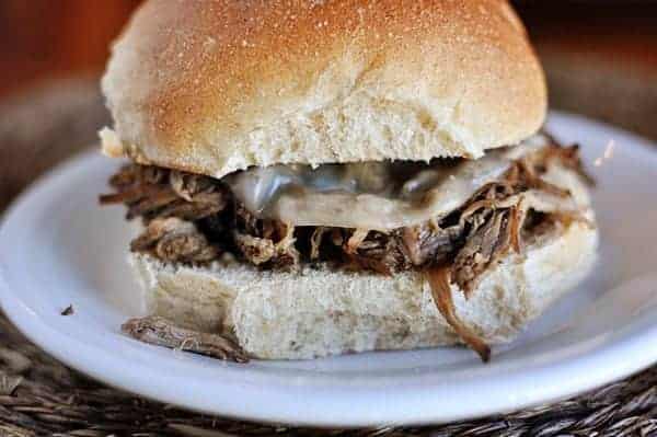 Beef sandwich on a white plate.