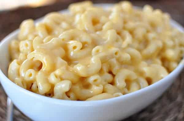 Creamy macaroni and cheese in a white bowl.