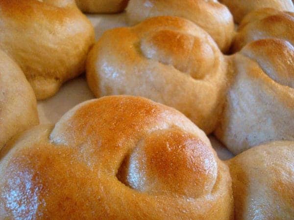 Golden brown bread knots in a sheet pan.