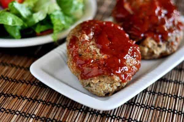 Small glazed meatloaf on a white plate.
