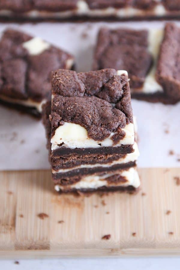 Black and white cheesecake brownies stacked on each other.