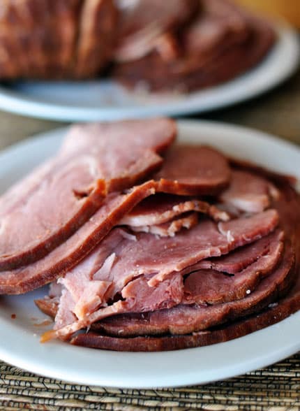 A plate full of sliced ham. 