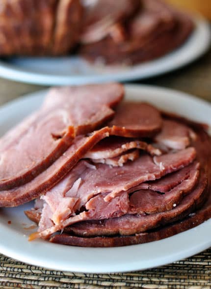 A plate full of sliced ham.
