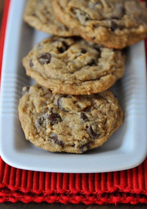 Top view of a rectangular white platter of chocolate chip cookes.