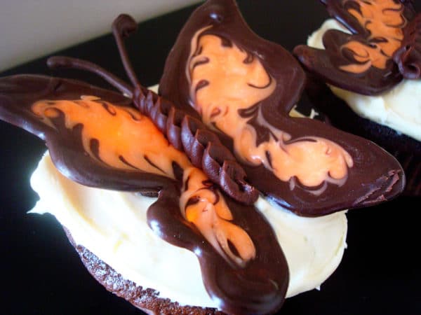 frosted cupcake with a chocolate butterfly on top