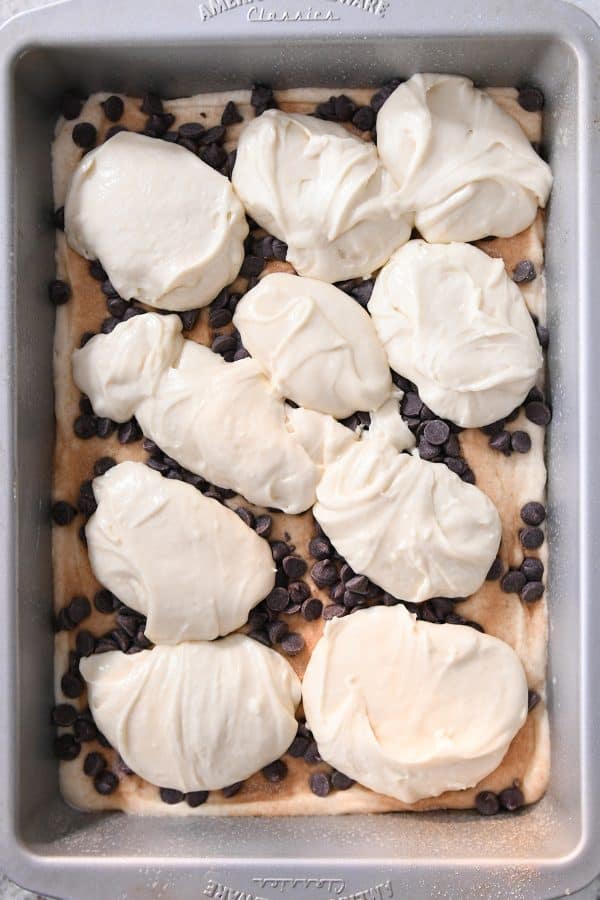 Spoonfuls of batter on top of chocolate chips in 9X13-inch pan.