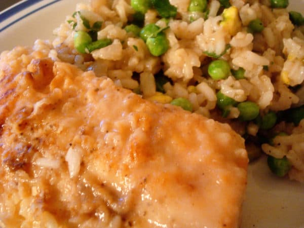 Chicken with a side of rice and peas.