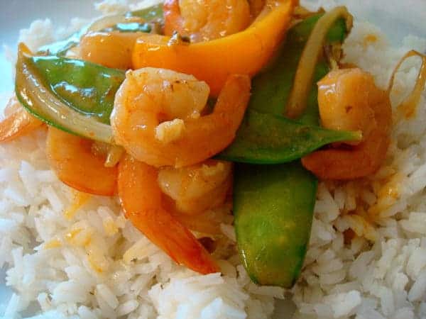 Shrimp and snow peas on white rice.