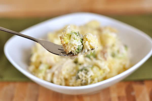 White dish full of broccoli cheese casserole.