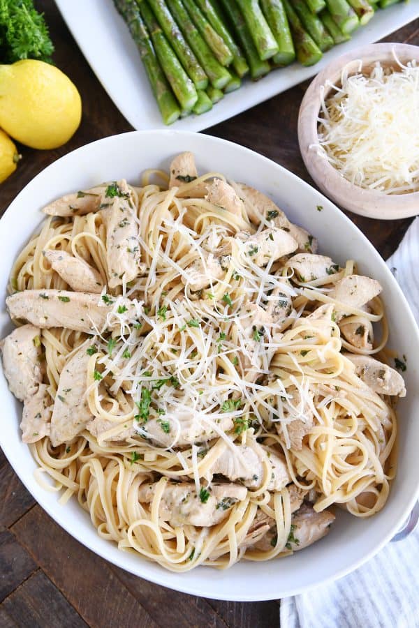 Top down view of lemon chicken pasta in white dish.