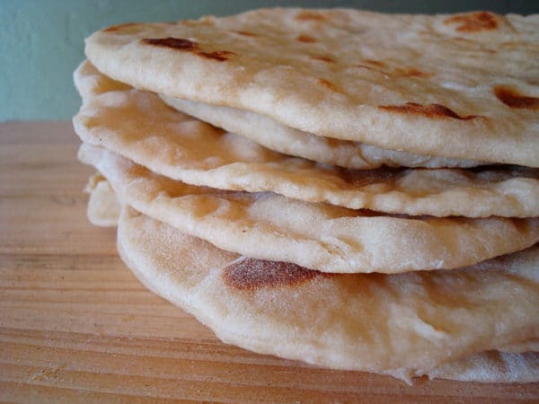 Stack of soft wrap bread on a table.