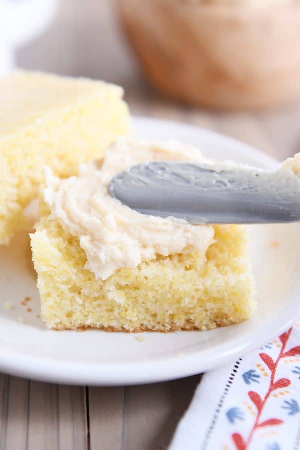Spreading fluffy honey butter on piece of best cornbread on the planet.