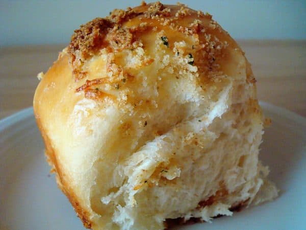 Parmesan crusted baked roll on a plate.