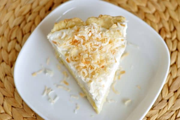 Top down view of coconut cream pie on white plate.