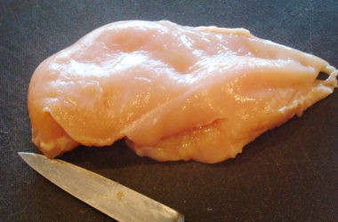 raw chicken breast about to be cut