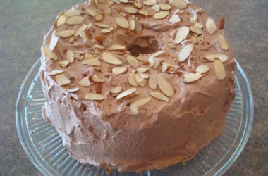 frosted angel food cake with sliced almonds on top