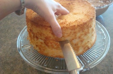 cutting the top off an angel food cake