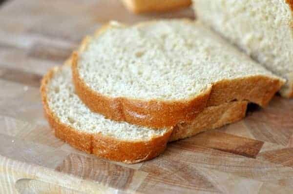 Thick slices of whole wheat bread on a cutting board.